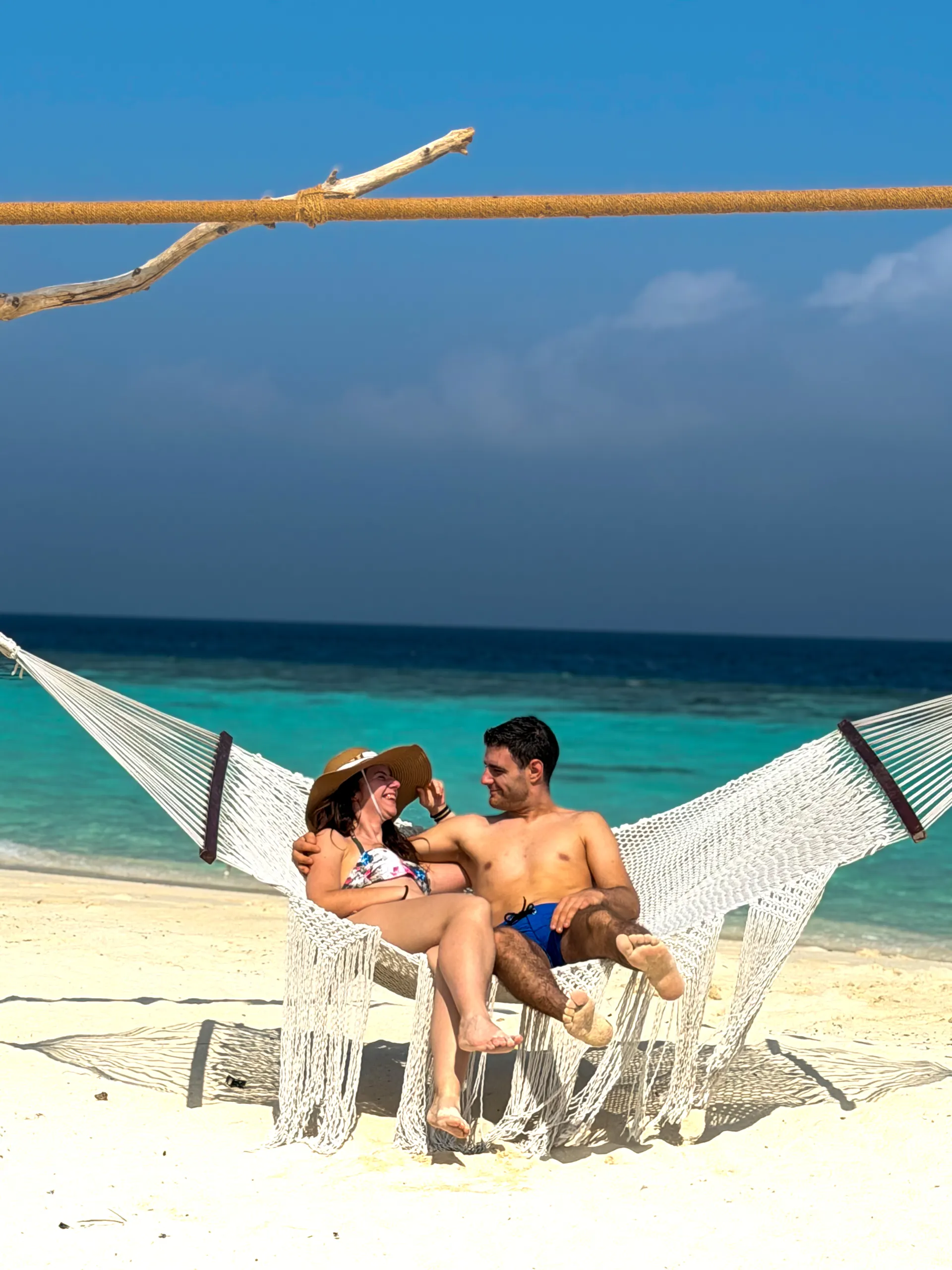 Couple relaxing in a beach hammock