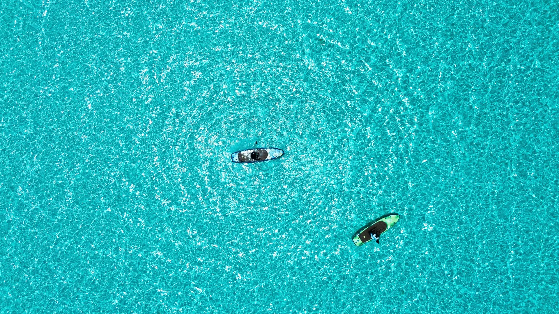 Kayaks gliding over the turquoise lagoon